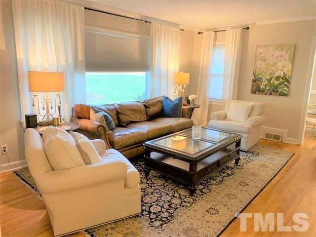 701 Dixie Trail Raleigh, NC 27607 - Photo 7 of 26 a living room with furniture and a large window