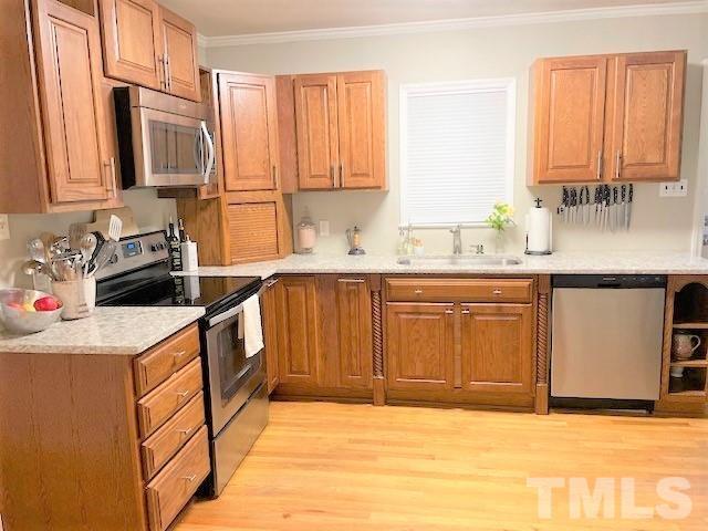 701 Dixie Trail Raleigh, NC 27607 - Photo 8 of 26 a kitchen with stainless steel appliances granite countertop a sink stove and refrigerator