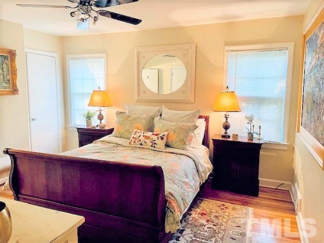 701 Dixie Trail Raleigh, NC 27607 - Photo 10 of 26 a bed room with a bed and a lamp