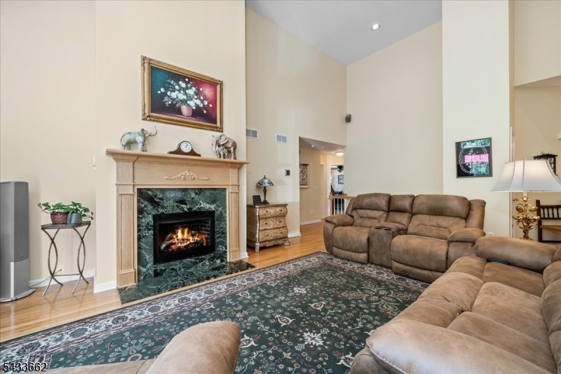 15 Bracken Hill Road Hamburg, NJ 07419 - Photo 10 of 44 a living room with furniture a flat screen tv and a fireplace