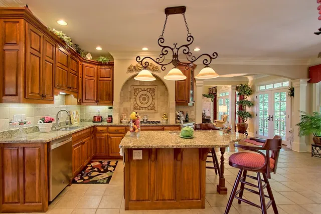 a view of a dining room with furniture and chandelier