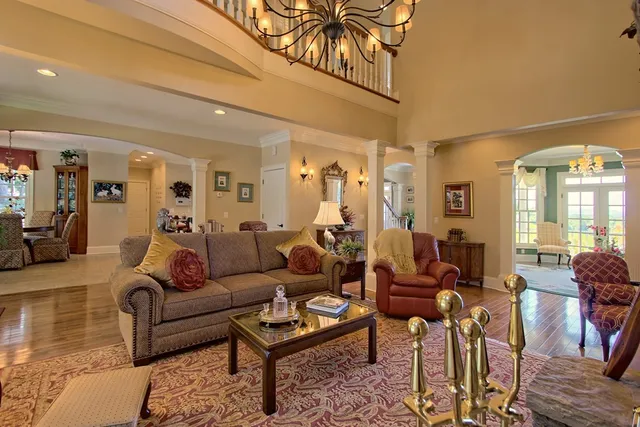 a living room with furniture and a chandelier
