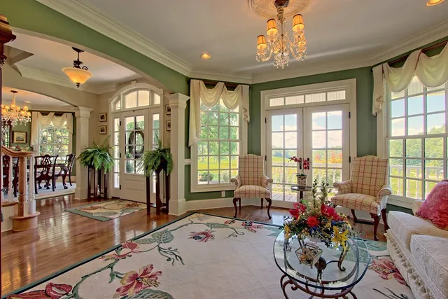 a bathroom with a tub and a large window