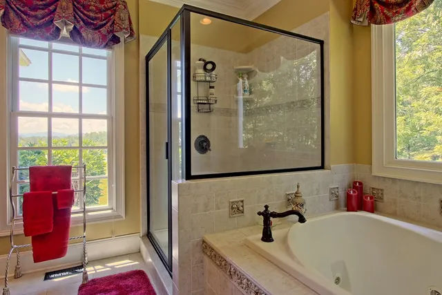 a vase of flowers sitting on a table in front of a bathroom