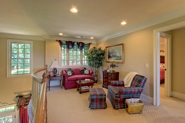 a view of a livingroom with workspace and a window