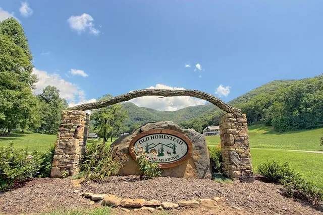a view of front door with wooden floor and stairs