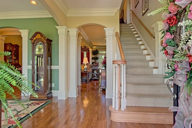 a view of entryway and hall with wooden floor
