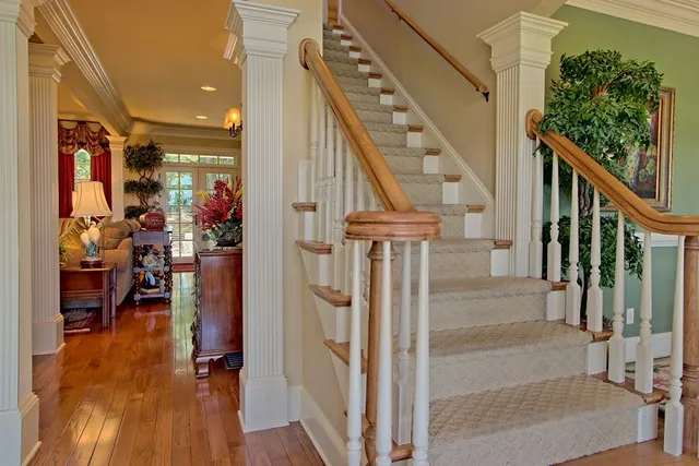 a view of staircase with furniture and a potted plant