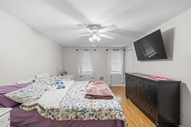 a large bedroom with a bed and a flat screen tv