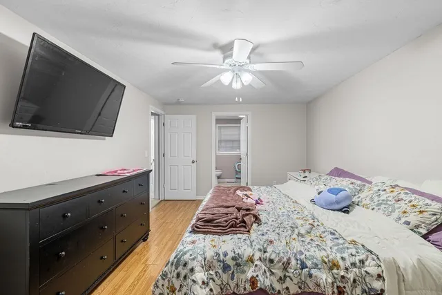 a bedroom with a bed and a flat screen tv