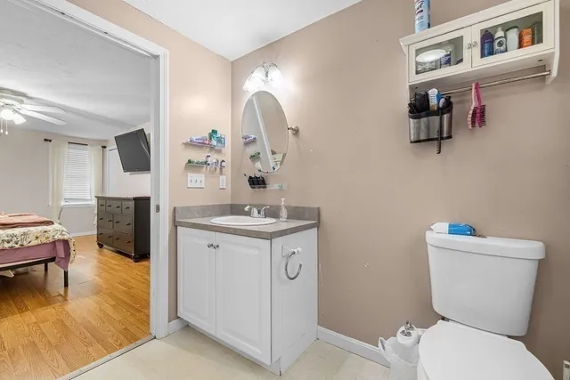a bathroom with a toilet a sink and a mirror