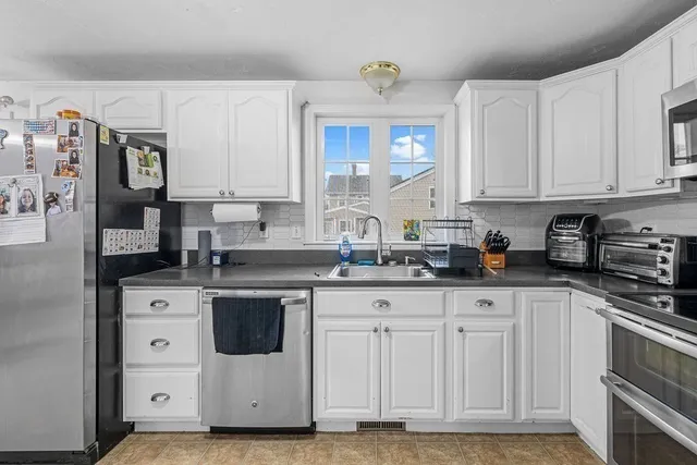 a kitchen with stainless steel appliances granite countertop a sink and cabinets