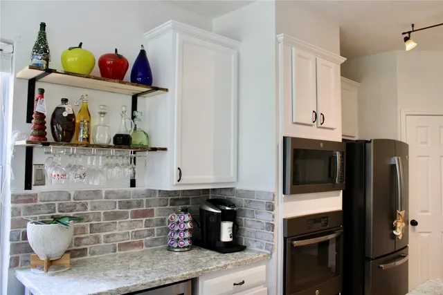 a kitchen with a refrigerator and cabinets