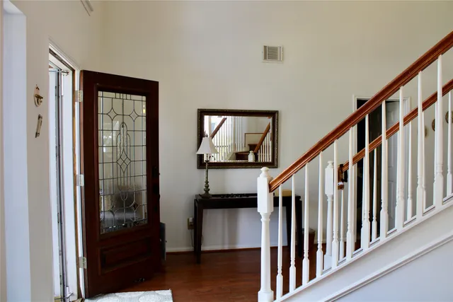 a view of an entryway with wooden floor and stairs