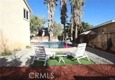 a view of backyard with outdoor seating and trees