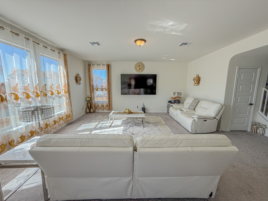 121 Outlaw Drive Jarrell, TX 76537 - Photo 14 of 32 a living room with furniture and a flat screen tv