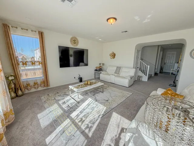 a view of a livingroom with furniture and a flat screen tv