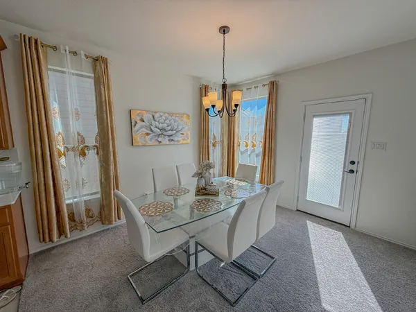 a dining room with furniture and window