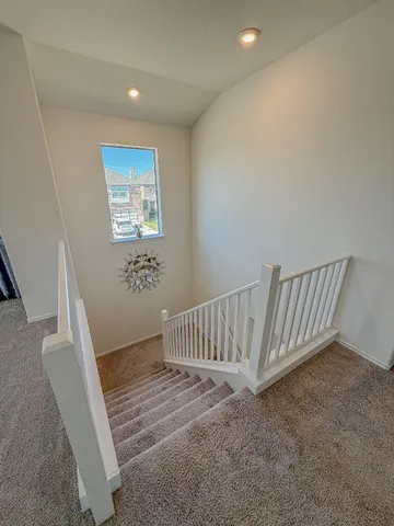 a large kitchen with a table and chairs