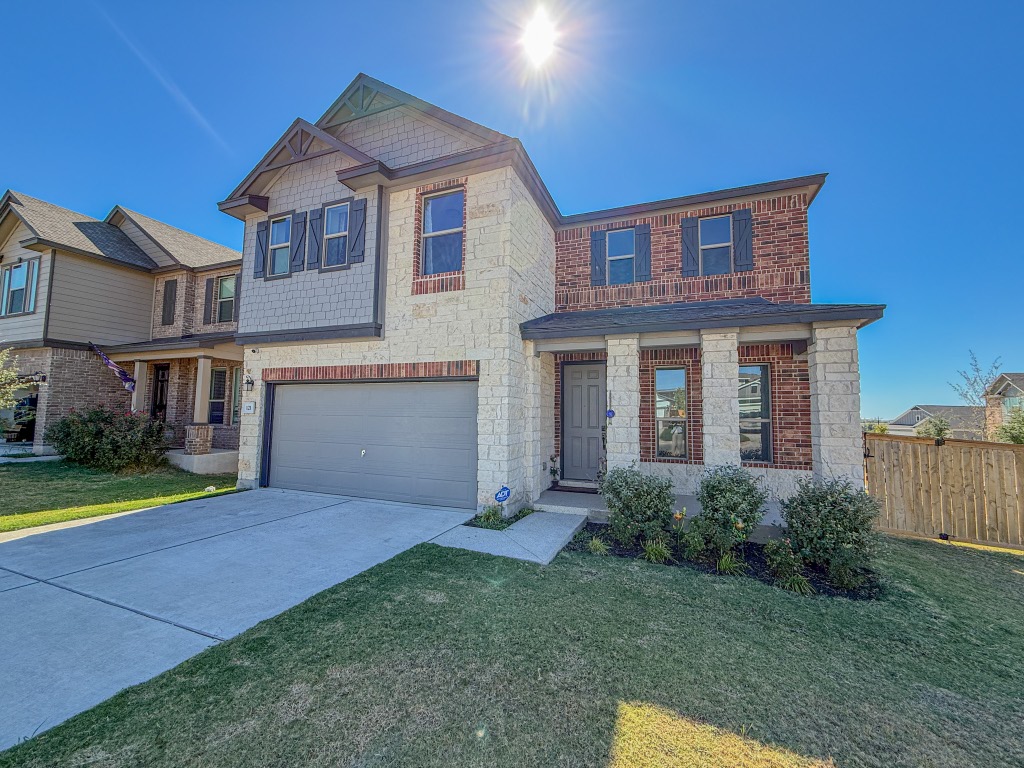121 Outlaw Drive Jarrell, TX 76537 - Photo 2 of 32 a front view of a house with a yard and garage