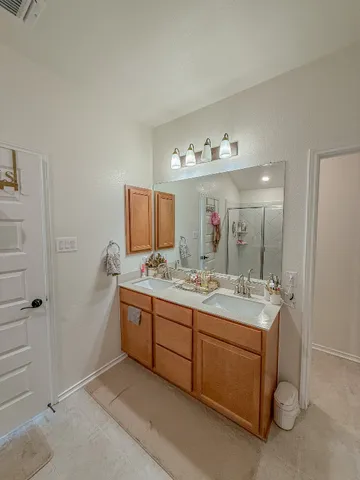a bathroom with a shower and a sink