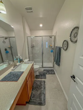 a bathroom with double vanity and a shower