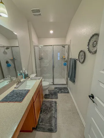 a bathroom with double vanity and a shower