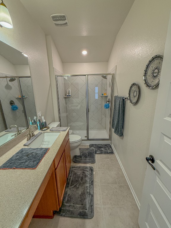 121 Outlaw Drive Jarrell, TX 76537 - Photo 26 of 32 a bathroom with double vanity and a shower