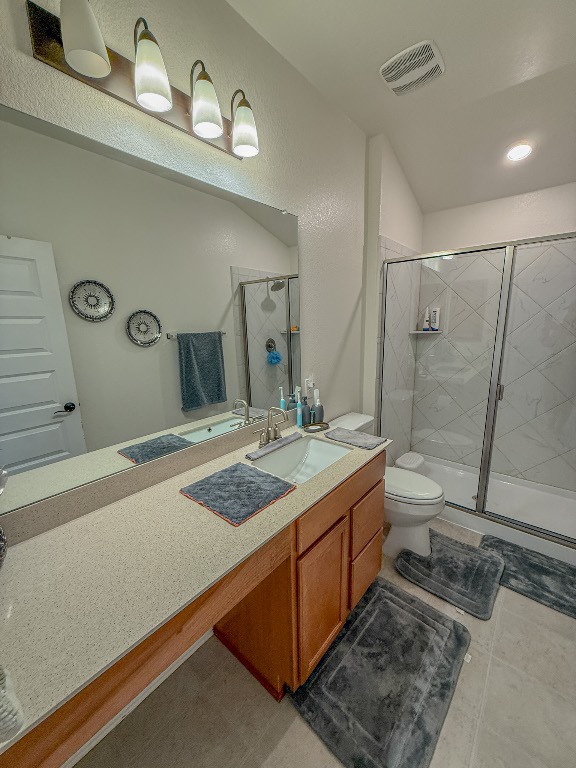 121 Outlaw Drive Jarrell, TX 76537 - Photo 27 of 32 a bathroom with a granite countertop sink a toilet and shower