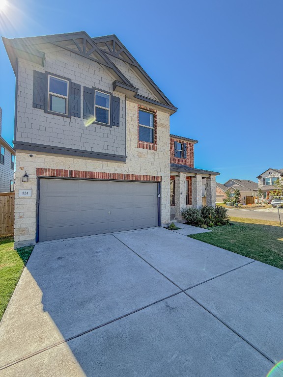 121 Outlaw Drive Jarrell, TX 76537 - Photo 3 of 32 a front view of a house with a yard and garage