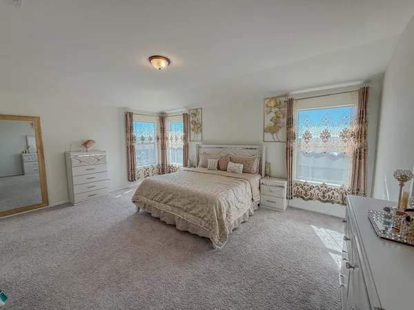 a spacious bedroom with a bed and a couch