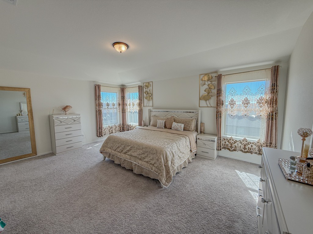 121 Outlaw Drive Jarrell, TX 76537 - Photo 6 of 32 a spacious bedroom with a bed and a couch