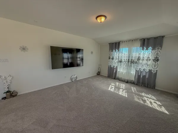 a view of a livingroom with an empty space and a window