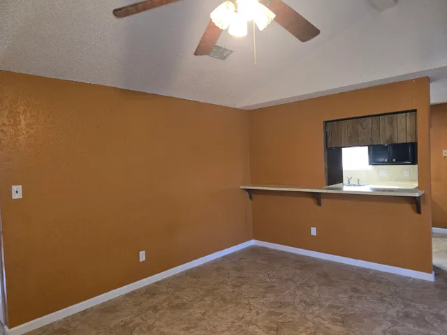 an empty room with a empty space and a ceiling fan