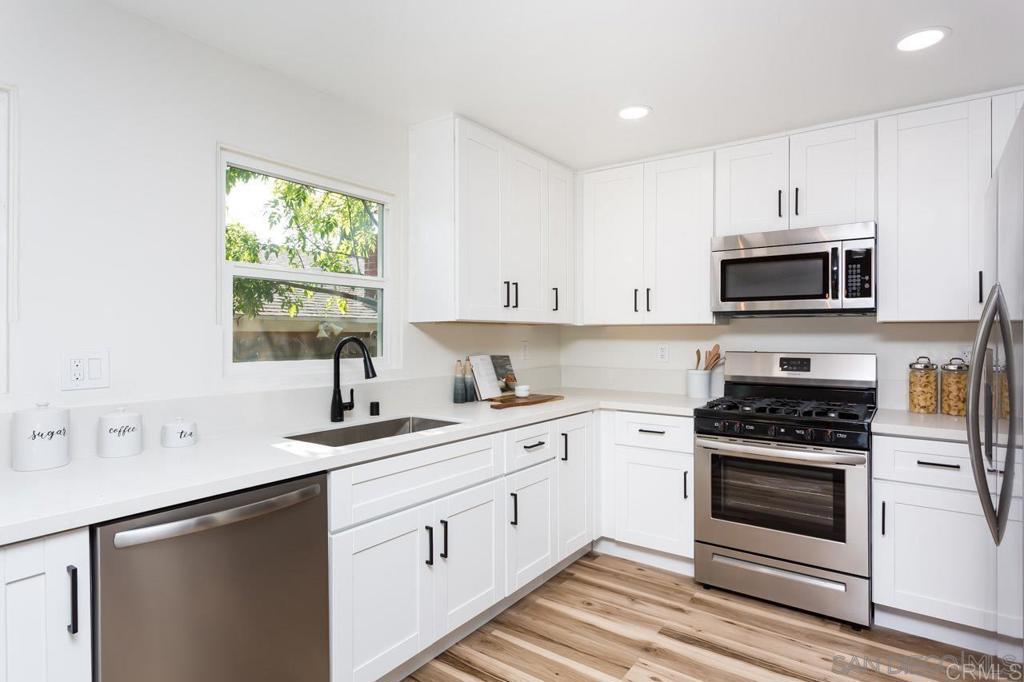 2610 Glebe Road Lemon Grove, CA 91945 - Photo 2 of 8 a kitchen with cabinets appliances a sink and a window