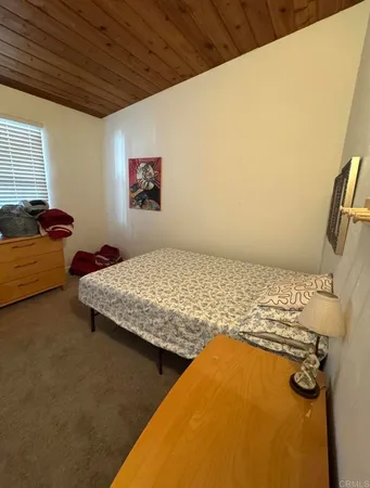 a bedroom with a bed and dresser