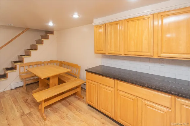 a living room with a sink and dishwasher with wooden floor