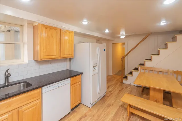 a kitchen with wooden cabinets and sink