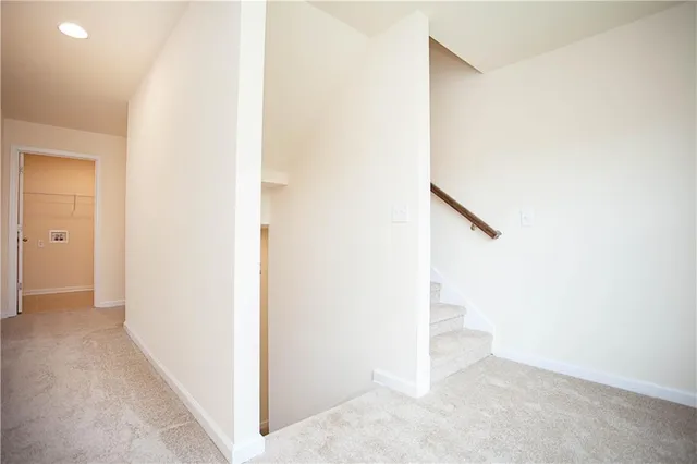an empty room with closet and a ceiling fan