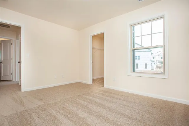 an empty room with windows and closet