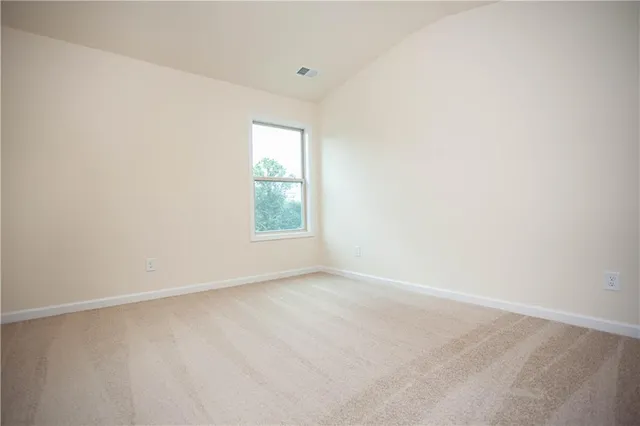 an aerial view of a house with pool garden and covered with green space