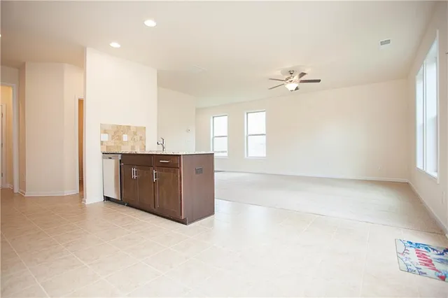 a spacious bathroom with a granite countertop sink a mirror and a