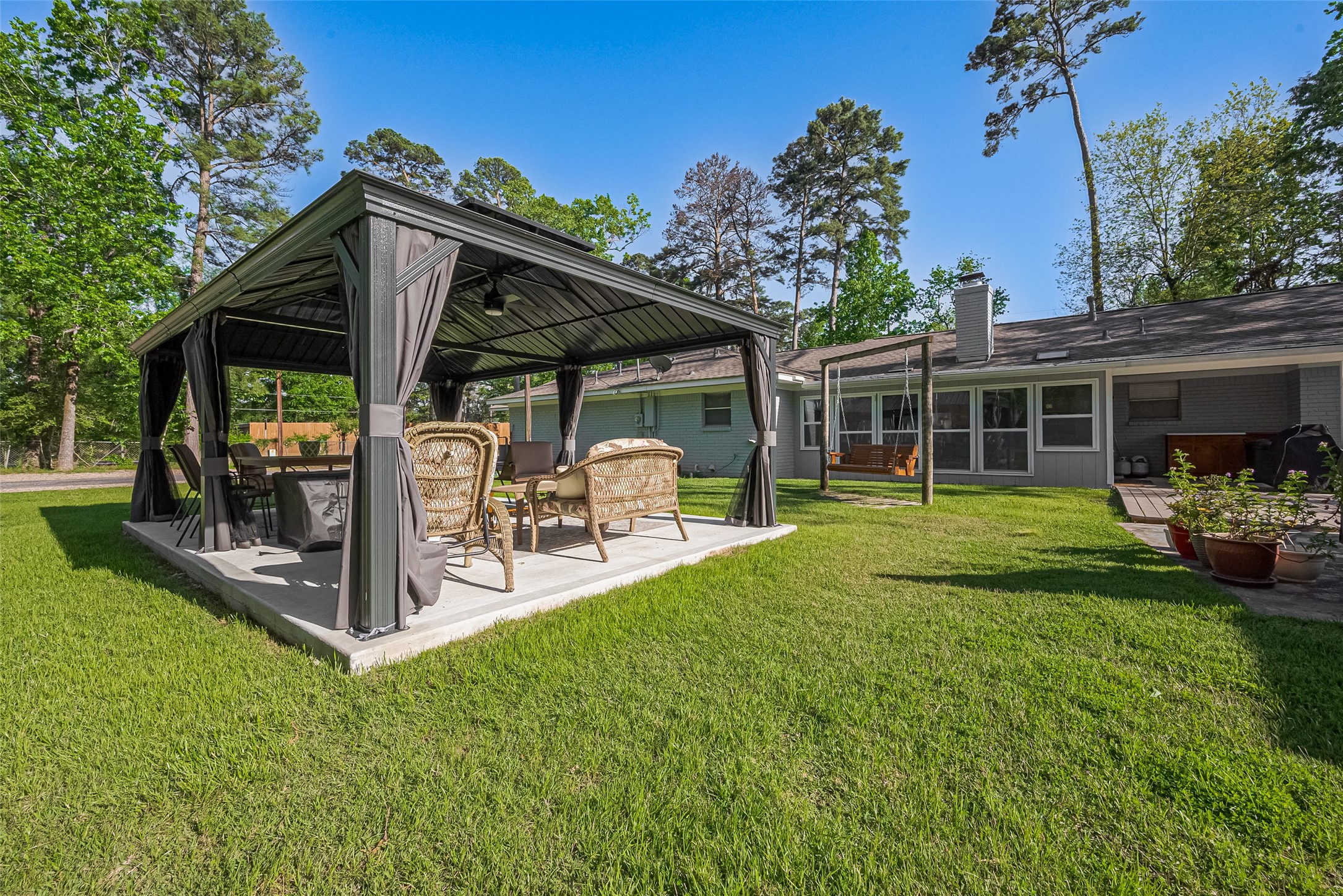 1535 Spring Hills Drive Spring, TX 77386 - Photo 13 of 44 Perfect for entertaining, it features a pergola-covered outdoor entertainment space.