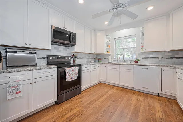 a spacious bedroom with a bed and a chandelier