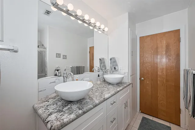 a view of a house with a big yard and a large tree