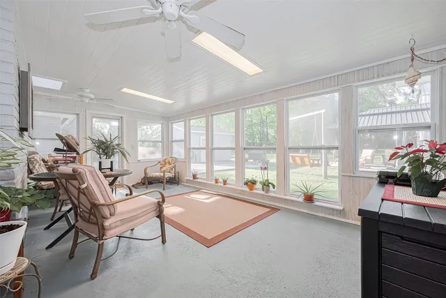 a view of a house with backyard and trees