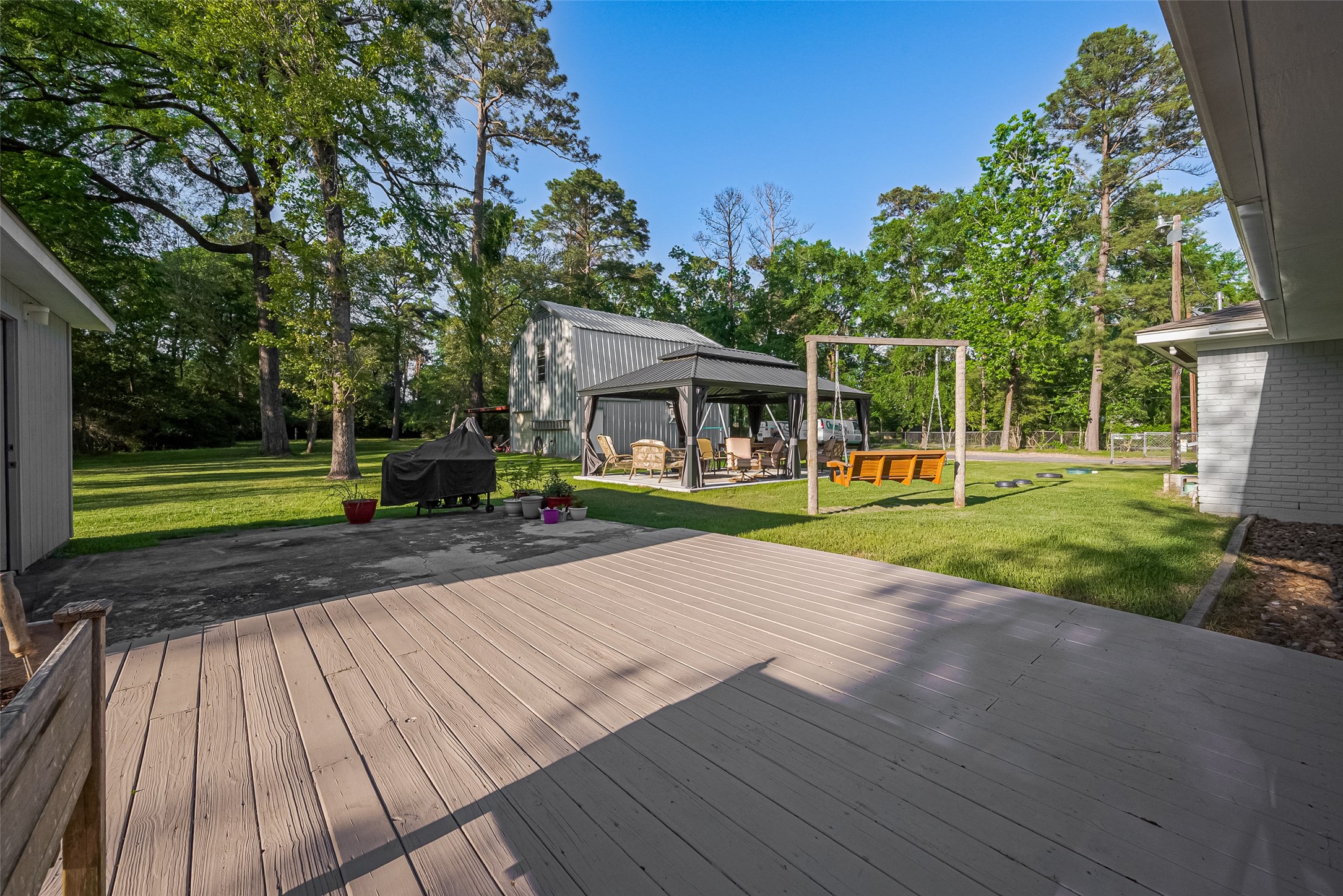 1535 Spring Hills Drive Spring, TX 77386 - Photo 40 of 44 Step onto the sun deck off the sunroom, ideal for entertaining or enjoying a tranquil coffee break.