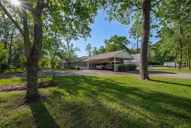 a view of a house with backyard porch and sitting area