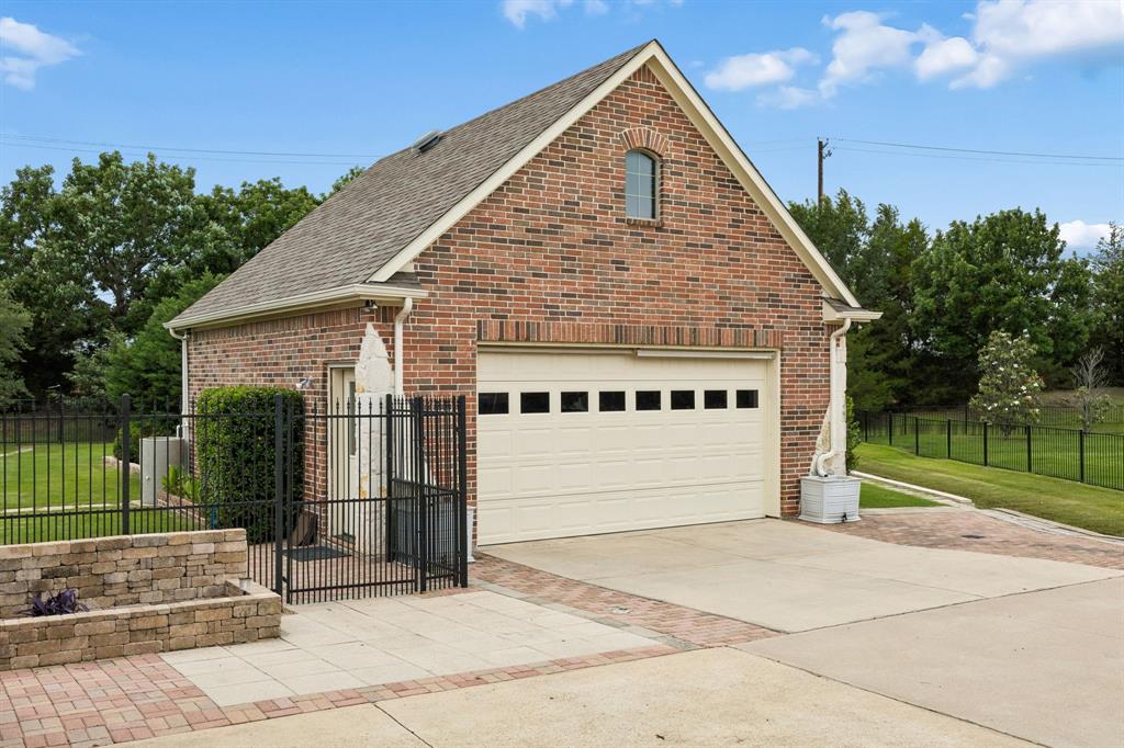 5802 Corinth Chapel Road Parker, TX 75002 - Photo 37 of 40 The property offers a stand-alone garage and workshop with two-level shelving, attic storage, and enough space for two vehicles.