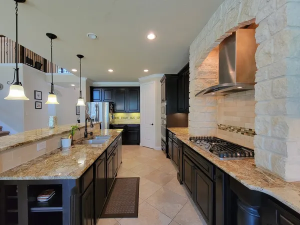 a kitchen with granite countertop a stove and a sink